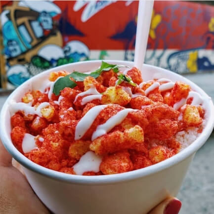 A dish of elotes chidos—Mexican street corn topped with Flamin' Hot Cheetos that add a satisfying and spicy crunch