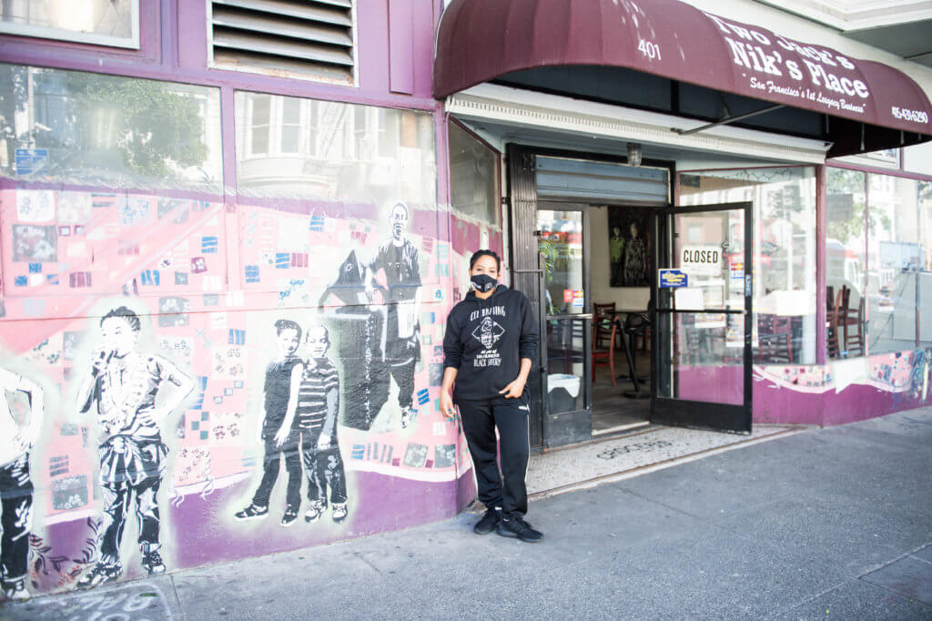 two jacks owner nikki cooper standing outside of restaurant